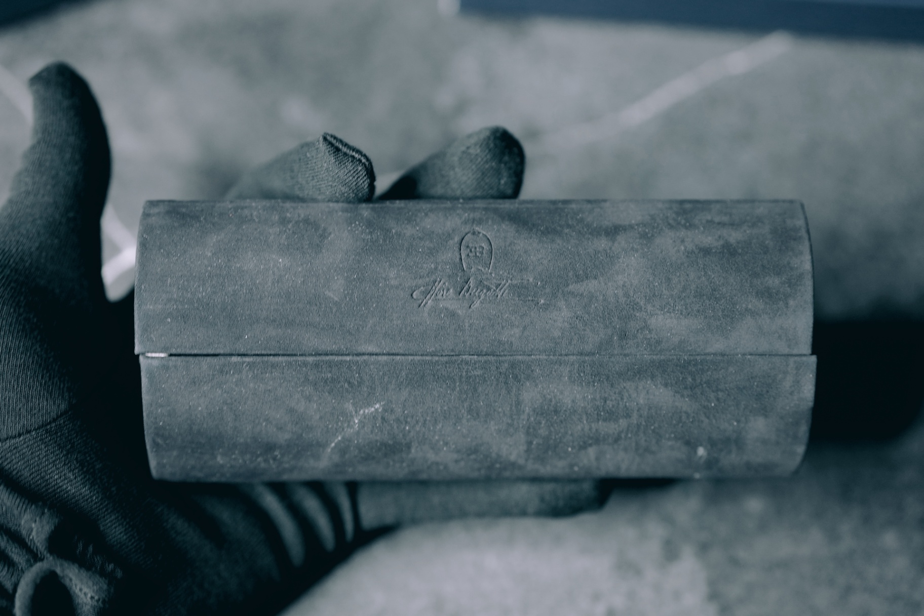 Closed Bugatti suede case in hand