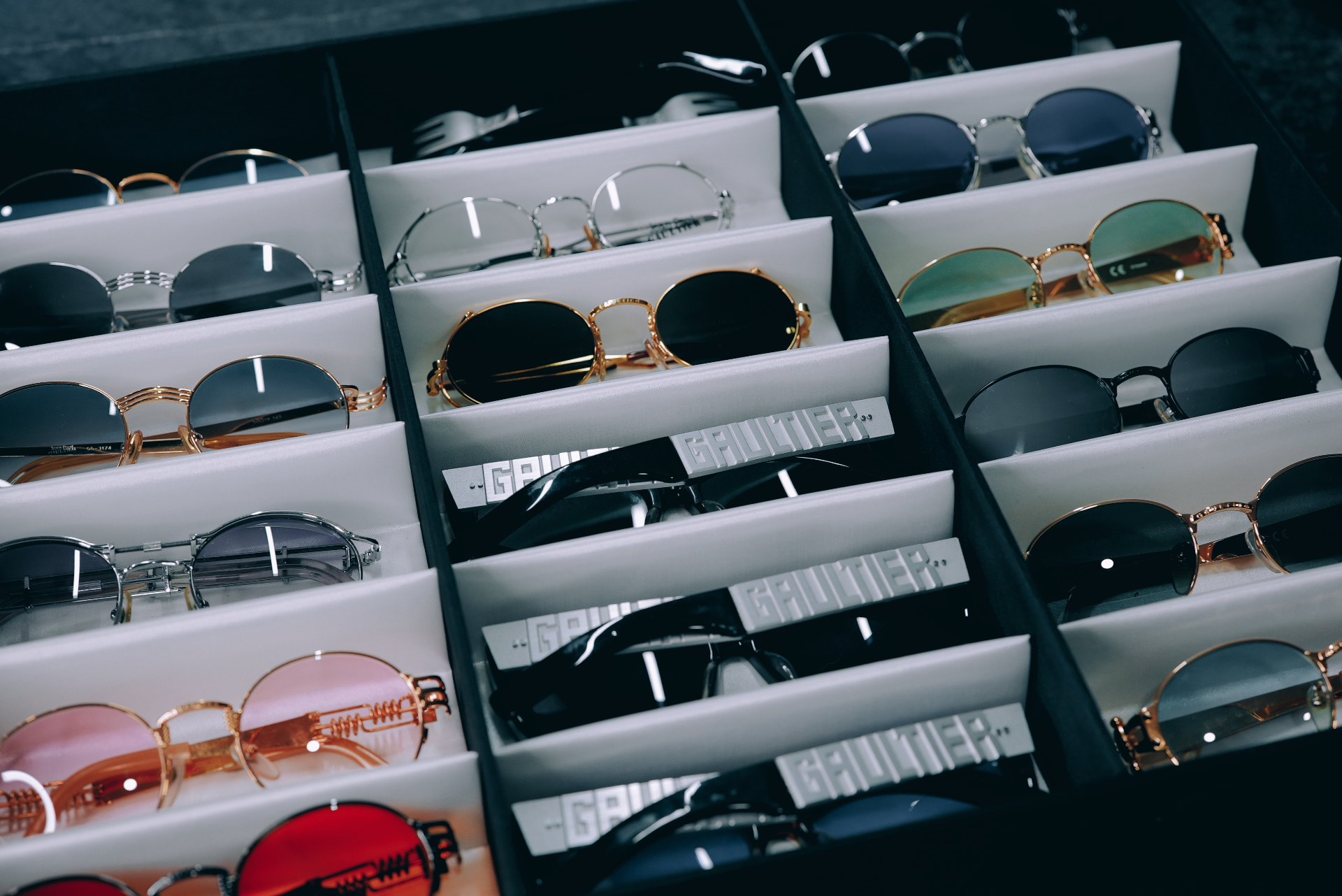 Drawer of rare vintage designer sunglasses arranged tonally — 858Vintage archive